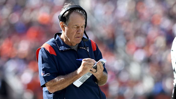 Oct 16, 2022; Cleveland, Ohio, USA;  New England Patriots head coach Bill Belichick takes notes during their game against the Cleveland Browns in the first quarter at FirstEnergy Stadium.