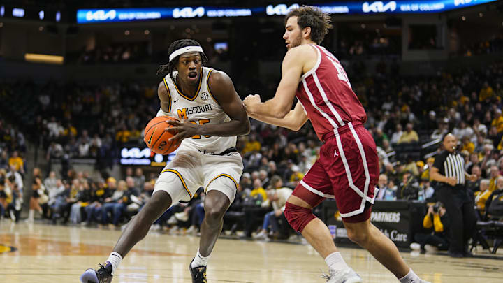 Feb 12, 2025; Columbia, Missouri, USA; Missouri Tigers guard Mark Mitchell (25) drives against Oklahoma Sooners forward Sam Godwin (10) during the first half at Mizzou Arena. Mandatory Credit: Jay Biggerstaff-Imagn Images