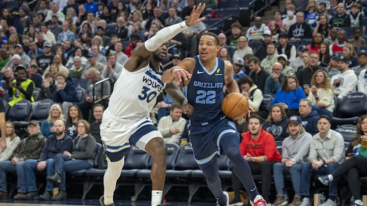 Jan 11, 2025; Minneapolis, Minnesota, USA; Memphis Grizzlies guard Desmond Bane (22) drives to the basket against Minnesota Timberwolves forward Julius Randle (30) in the second half at Target Center. Mandatory Credit: Jesse Johnson-Imagn Images