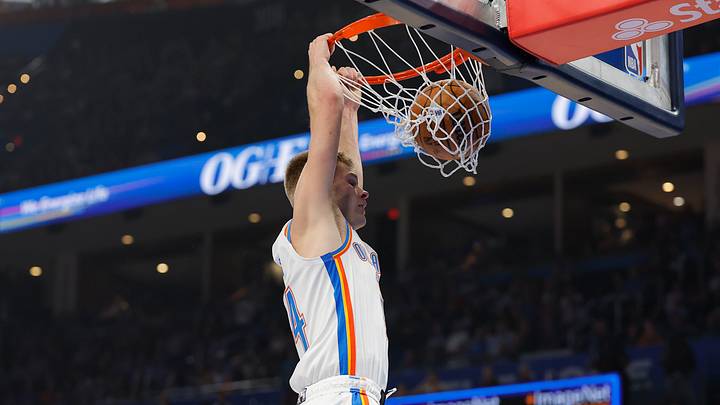 Oct 25, 2026; Oklahoma City, Oklahoma, USA; Oklahoma City Thunder guard Bennett Stirtz (14) dunks against the Los Angeles Clippers during the first half at Paycom Center. Mandatory Credit: Alonzo Adams-Imagn Images