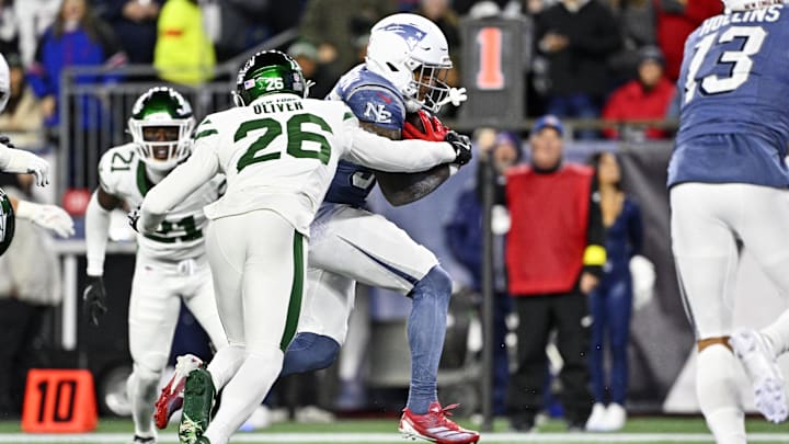 Nov 13, 2025; Foxborough, Massachusetts, USA; New England Patriots running back TreVeyon Henderson (32) scores a touchdown during the first half against the New York Jets at Gillette Stadium. Mandatory Credit: Eric Canha-Imagn Images