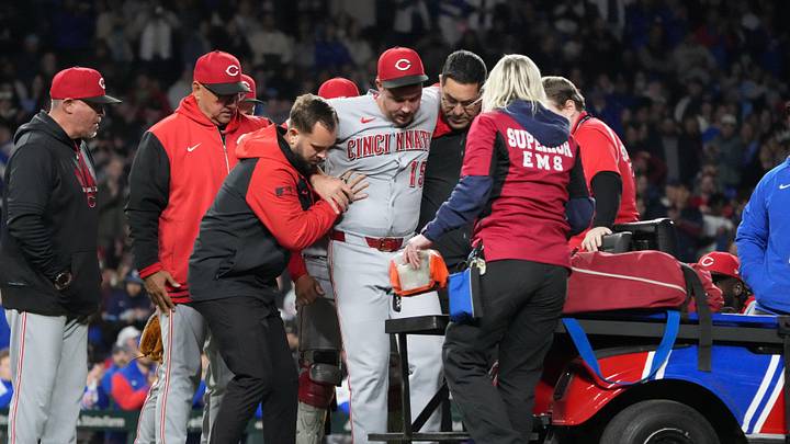 May 5, 2026; Chicago, Illinois, USA; Cincinnati Reds pitcher Emilio Pagan (15) reacts to an injury during the ninth inning against the Chicago Cubs at Wrigley Field. Mandatory Credit: David Banks-Imagn Images