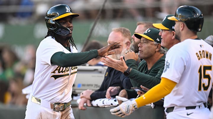 Sep 4, 2024; Oakland, California, USA; Oakland Athletics outfielder Lawrence Butler (left) celebrates his run against the Seattle Mariners in the first inning at Oakland-Alameda County Coliseum. Mandatory Credit: Eakin Howard-Imagn Images