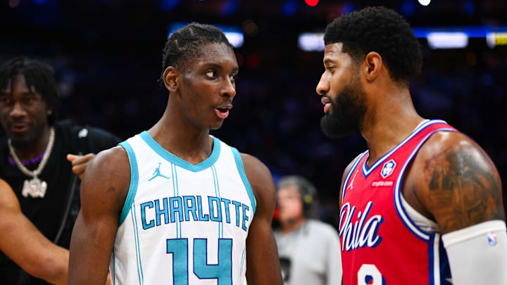 Dec 20, 2024; Philadelphia, Pennsylvania, USA; Charlotte Hornets forward Moussa Diabate (14) reacts with Philadelphia 76ers forward Paul George (8) after the game at Wells Fargo Center. Mandatory Credit: Kyle Ross-Imagn Images