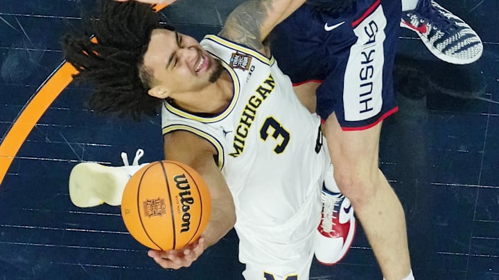 Apr 6, 2026; Indianapolis, IN, USA; Michigan Wolverines guard Elliot Cadeau (3) shoots the ball against UConn Huskies guard Braylon Mullins (24) during the second half in the national championship of the Final Four of the men's 2026 NCAA Tournament between the  and the Michigan Wolverines at Lucas Oil Stadium.