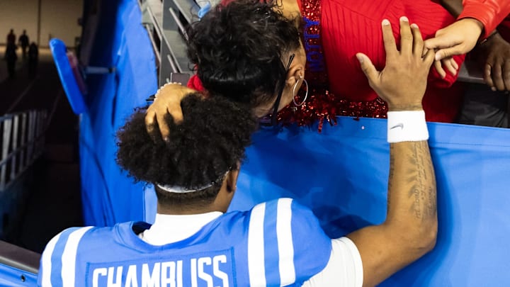 Quarterback Trinidad Chambliss prays with his mother prior to the game against the Miami. Quarterback Trinidad Chambliss prays with his mother prior to the game against the Miami.