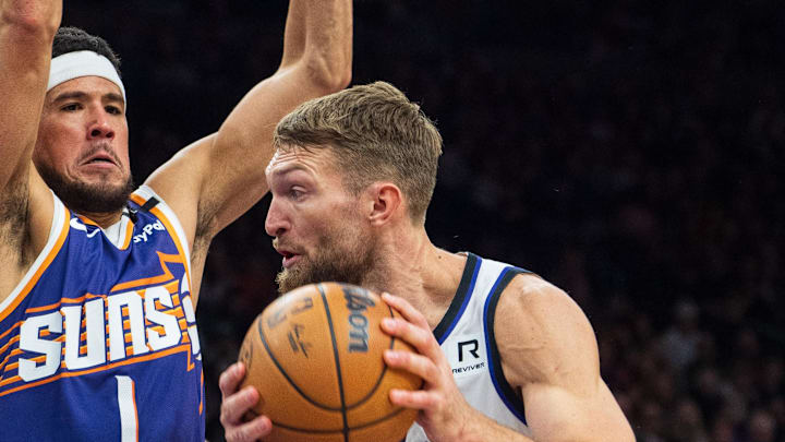 Nov 10, 2024; Phoenix, Arizona, USA; Phoenix Suns guard Devin Booker (1) defends against Sacramento Kings forward-center Domantas Sabonis (11) in the second half during a game at Footprint Center.