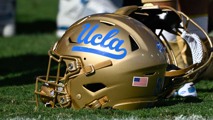 Nov 30, 2024; Pasadena, California, USA; UCLA Bruins helmets during pregame warmups before playing the Fresno State Bulldogs at Rose Bowl. Mandatory Credit: Robert Hanashiro-Imagn Images