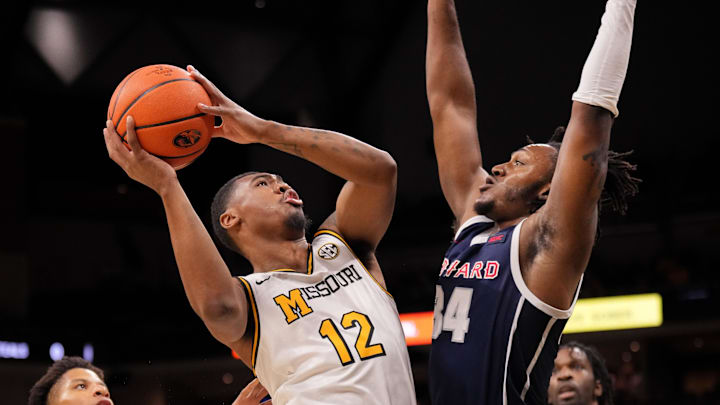 Nov 8, 2024; Columbia, Missouri, USA; Missouri Tigers guard Tony Perkins (12) shoots as Howard Bison guard Bryce Harris (34) defends during the first half at Mizzou Arena. Mandatory Credit: Denny Medley-Imagn Images