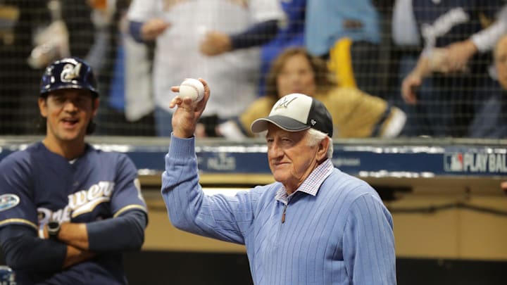 Legendary Brewers radio broadcaster Bob Uecker salutes the crowd after throwing out the first pitch in Game 1 of the National League Championship Series against the Los Angeles Dodgers Oct. 12, 2018, at Miller Park in Milwaukee.