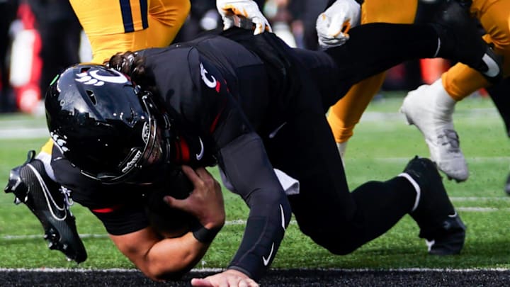 Cincinnati Bearcats quarterback Brendan Sorsby (2) scores a touchdown in the fourth quarter of a college football game between the Cincinnati Bearcats and West Virginia Mountaineers, Saturday, Nov. 9, 2024, at Nippert Stadium in Cincinnati. Mountaineers won 31-24. Cincinnati Bearcats quarterback Brendan Sorsby (2) scores a touchdown in the fourth quarter of a college football game between the Cincinnati Bearcats and West Virginia Mountaineers, Saturday, Nov. 9, 2024, at Nippert Stadium in Cincinnati. Mountaineers won 31-24.
