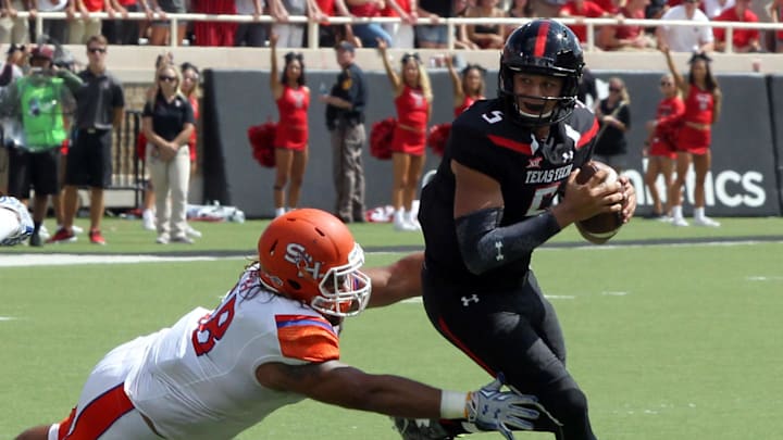 Sep 5, 2015; Lubbock, TX, USA; Sam Houston State Bearkats defensive tackle James DeLaRosa (68) tries to tackle Texas Tech Red Raiders quarterback Patrick Mahomes II (5) during the first half at Jones AT&T Stadium. Mandatory Credit: Michael C. Johnson-Imagn Images