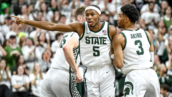 Michigan State's Tre Holloman, center, gets back on defense after a 3-pointer against Iowa during