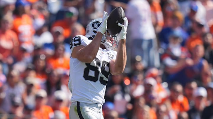 Oct 6, 2024; Denver, Colorado, USA; Las Vegas Raiders tight end Brock Bowers (89) pulls a reception for a touchdown in the first quarter against the Denver Broncos at Empower Field at Mile High. Mandatory Credit: Ron Chenoy-Imagn Images
