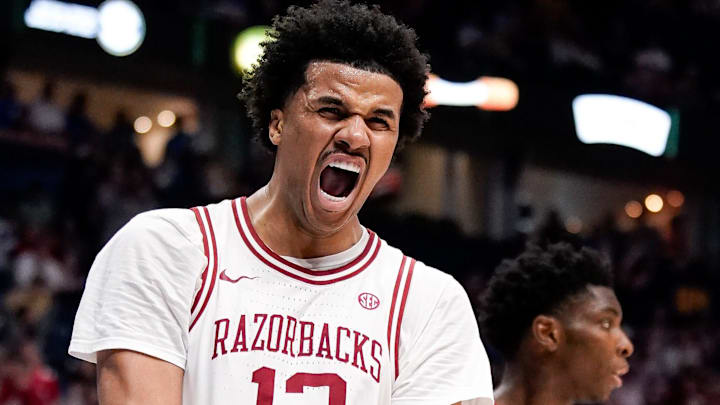 Arkansas forward Malique Ewin (12) celebrates dunking against Mississippi during the second half of a SEC tournament semifinal game at Bridgestone Arena in Nashville, Tenn., Saturday, March 14, 2026.