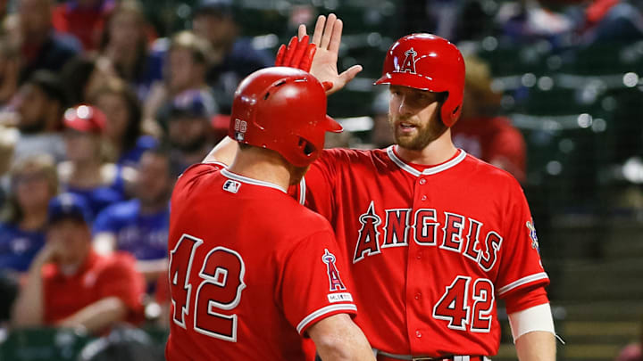 Apr 15, 2019; Arlington, TX, USA; Los Angeles Angels right fielder Kole Calhoun (left) high fives third baseman Zack Cozart (right) after hitting a two run home run during the eighth inning against the Texas Rangers at Globe Life Park in Arlington. 