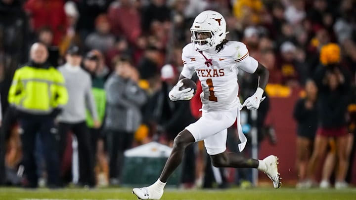 Nov 18, 2023; Ames, Iowa, USA; Texas Longhorns wide receiver Xavier Worthy (1) carries the ball in the first half of the Longhorns' game against the Iowa State Cyclones at Jack Trice Stadium. Mandatory Credit: Sara Diggins-USA TODAY Sports