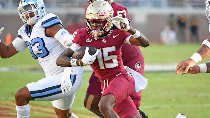 Nov 2, 2024; Tallahassee, Florida, USA;  Florida State Seminoes receiver Lawayne McCoy (15) runs the ball for a two point conversion against the North Carolina Tarheels in the first quarter at Doak S. Campbell Stadium. Mandatory Credit: Robert Myers-Imagn Images
