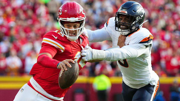 Nov 10, 2024; Kansas City, Missouri, USA; Kansas City Chiefs quarterback Patrick Mahomes (15) runs the ball against Denver Broncos linebacker Jonathon Cooper (0) during the second half at GEHA Field at Arrowhead Stadium. 