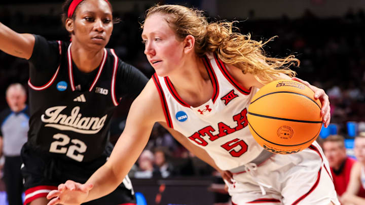 Mar 21, 2025; Columbia, South Carolina, USA; Utah Utes guard Gianna Kneepkens (5) drives past Indiana Hoosiers guard Chloe Moore-McNeil (22) in the second half at Colonial Life Arena. Mandatory Credit: Jeff Blake-Imagn Images