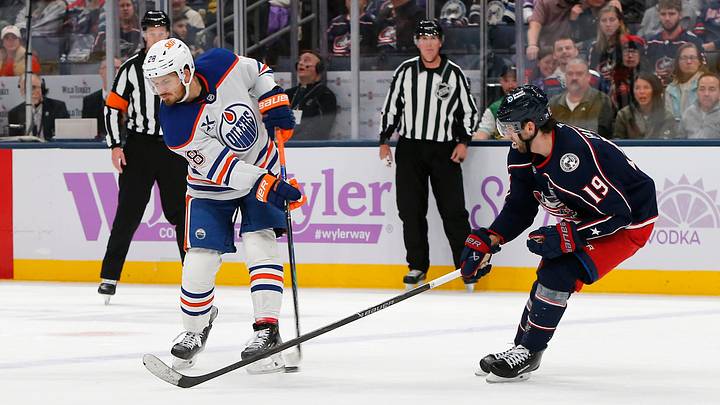 Nov 13, 2025; Columbus, Ohio, USA; Edmonton Oilers center Jack Roslovic (28) passes the puck as Columbus Blue Jackets center Adam Fantilli (19) defends during the third period at Nationwide Arena. Mandatory Credit: Russell LaBounty-Imagn Images Nov 13, 2025; Columbus, Ohio, USA; Edmonton Oilers center Jack Roslovic (28) passes the puck as Columbus Blue Jackets center Adam Fantilli (19) defends during the third period at Nationwide Arena. Mandatory Credit: Russell LaBounty-Imagn Images