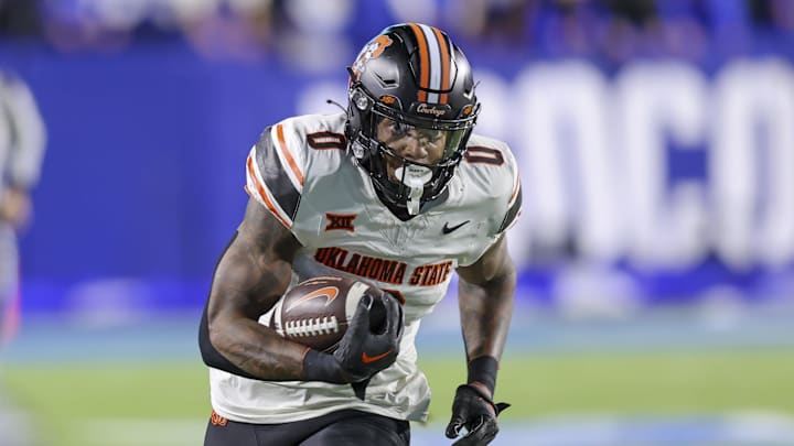 Oct 18, 2024; Provo, Utah, USA; Oklahoma State Cowboys running back Ollie Gordon II (0) runs for a catch for a touchdown against the Brigham Young Cougars during the first quarter at LaVell Edwards Stadium. Mandatory Credit: Rob Gray-Imagn Images