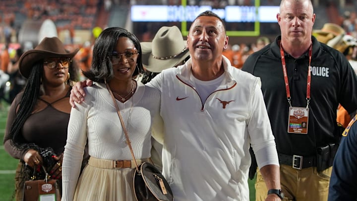 Texas Longhorns head coach Steve Sarkisian and his wife Loreal Sarkisian walk off the field after winning 31-14 against Kentucky Wildcats.