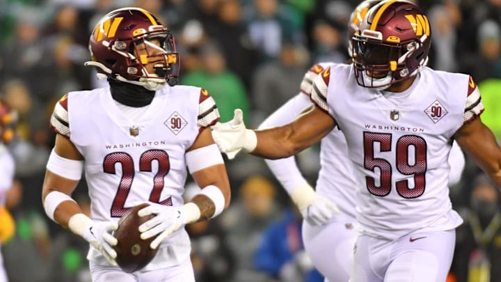 Washington Commanders safety Darrick Forrest celebrates his interception with linebacker Jon Bostic 