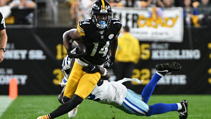 Pittsburgh Steelers wide receiver George Pickens breaks a tackle by Dallas Cowboys cornerback Jourdan Lewis.