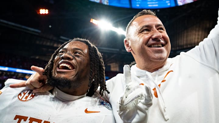 Texas Longhorns running back Jaydon Blue and head coach Steve Sarkisian celebrate a double overtime win over Arizona State.