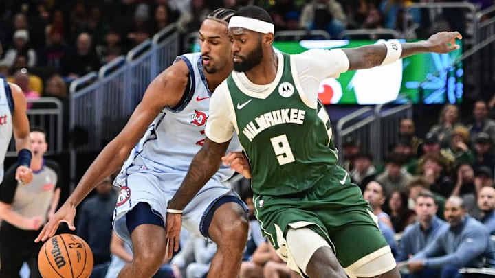 Dec 21, 2024; Milwaukee, Wisconsin, USA; Washington Wizards center Alex Sarr (20) and Milwaukee Bucks forward Bobby Portis (9) reach for the ball in the third quarter at Fiserv Forum. Mandatory Credit: Benny Sieu-Imagn Images