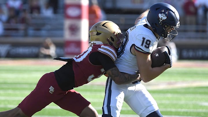 Oct 18, 2025; Chestnut Hill, Massachusetts, USA; Boston College Eagles defensive back TJ Green (30) tackles UConn Huskies wide receiver Jackson Harper (19) during the second half at Alumni Stadium. Mandatory Credit: Bob DeChiara-Imagn Images Oct 18, 2025; Chestnut Hill, Massachusetts, USA; Boston College Eagles defensive back TJ Green (30) tackles UConn Huskies wide receiver Jackson Harper (19) during the second half at Alumni Stadium. Mandatory Credit: Bob DeChiara-Imagn Images