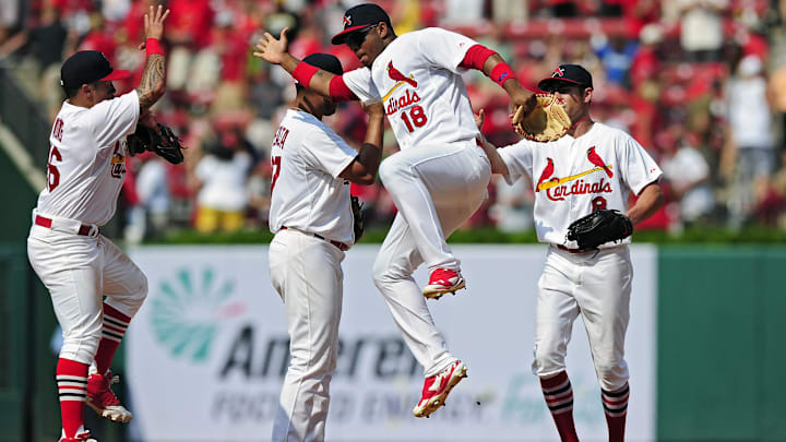 Aug 3, 2014; St. Louis, MO, USA; St. Louis Cardinals right fielder Oscar Taveras (18) celebrates with second baseman Kolten Wong (16) after defeating the Milwaukee Brewers at Busch Stadium. The Cardinals defeated the Brewers 3-2. Mandatory Credit: Jeff Curry-Imagn Images