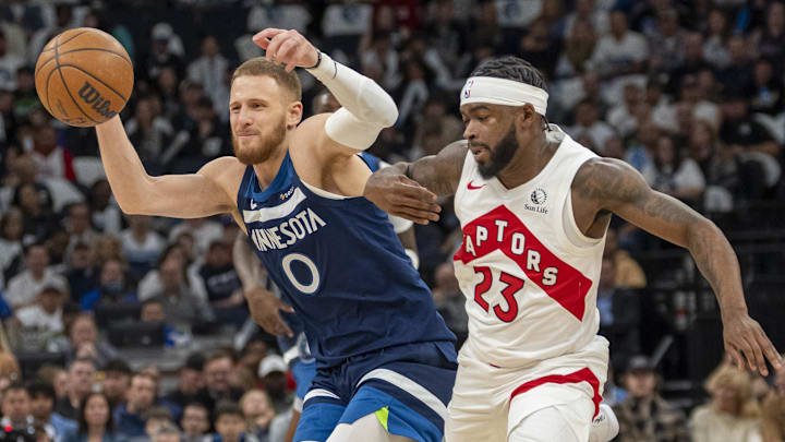 Minnesota Timberwolves guard Donte DiVincenzo (0) loses the ball and is fouled by Toronto Raptors guard Jamal Shead in the first half at Target Center in Minneapolis on Oct. 26, 2024.