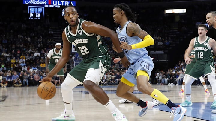 Dec 15, 2022; Memphis, Tennessee, USA; Milwaukee Bucks forward Khris Middleton (22) dribbles as Memphis Grizzlies guard Ja Morant (12) defends during the second half at FedExForum. Mandatory Credit: Petre Thomas-Imagn Images