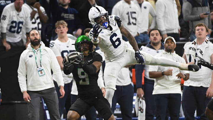 Dec 7, 2024; Indianapolis, IN, USA; Oregon Ducks defensive back Nikko Reed (9) and Penn State Nittany Lions wide receiver Harrison Wallace III (6) battle for a pass during the fourth quarter in the 2024 Big Ten Championship game at Lucas Oil Stadium. Mandatory Credit: Robert Goddin-Imagn Images