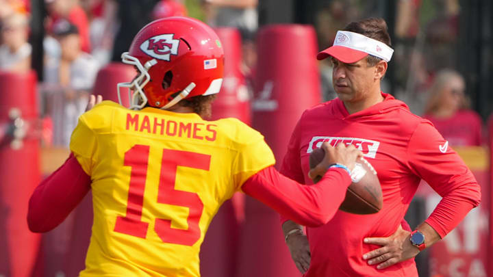 Jul 26, 2024; Kansas City, MO, USA; Kansas City Chiefs quarterback Patrick Mahomes (15) throws a pass as general manager Brett Veach watches in the background during training camp at Missouri Western State University. Mandatory Credit: Denny Medley-Imagn Images