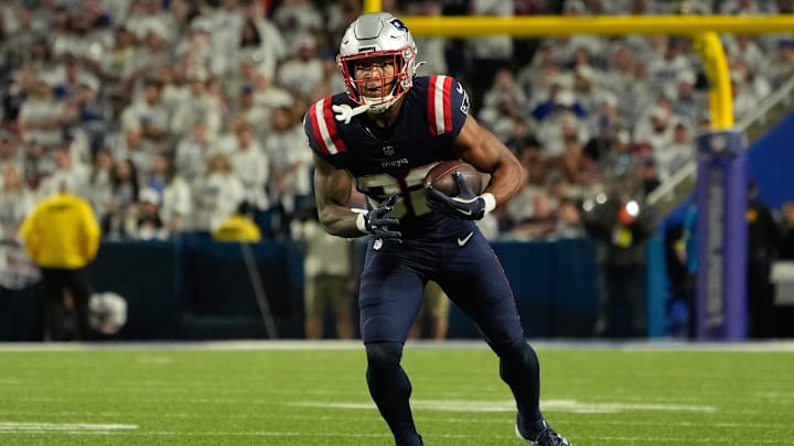 Oct 5, 2025; Orchard Park, New York, USA; New England Patriots running back Treveyon Henderson (32) runs with the ball against the Buffalo Bills during the second half at Highmark Stadium. 