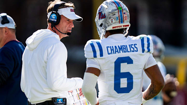 Ole Miss head coach Lane Kiffin talks with quarterback Trinidad Chambliss (6) during a college football game between Mississippi State and Ole Miss at Davis Wade Stadium in Starkville, Miss., on Friday, Nov. 28, 2025. Ole Miss defeated Mississippi State 38-19 in the Egg Bowl.
