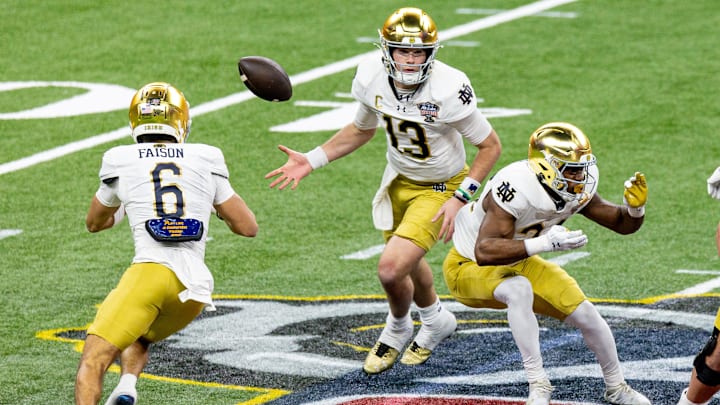 Jan 2, 2025; New Orleans, LA, USA;  Notre Dame Fighting Irish quarterback Riley Leonard (13)  flips the ball to Notre Dame Fighting Irish wide receiver Jordan Faison (6) on a play against the Georgia Bulldogs during the second half at Caesars Superdome. Mandatory Credit: Stephen Lew-Imagn Images