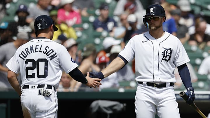 Detroit Tigers first baseman Spencer Torkelson (20) receives congratulations from left fielder Austin Meadows (17) after scoring. 