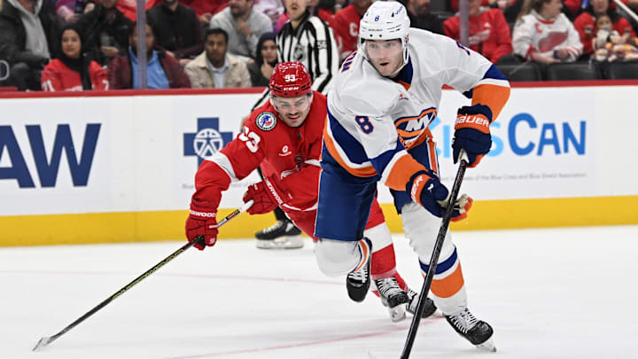 Nov 21, 2024; Detroit, Michigan, USA;  New York Islanders defenseman Noah Dobson (8) skates past Detroit Red Wings right wing Alex DeBrincat (93) in the first period at Little Caesars Arena. Mandatory Credit: Lon Horwedel-Imagn Images