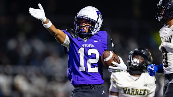 Brownsburg High School junior Branden Sharpe (12) gestures after making a first down.