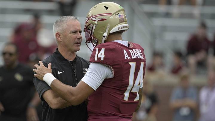 Florida State head coach Mike Norvell talks with quarterback Ashton Daniels (14)