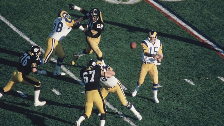 Jan 20, 1980; Pasadena, CA, USA; FILE PHOTO; Los Angeles Rams quarterback Vince Ferragamo (15) throws against Pittsburgh Steelers defenders L.C. Greenwood (68), John Banaszak (76) and Gary Dunn (67) during Super Bowl XIV at the Rose Bowl. The Steelers defeated the Rams 31-19. Mandatory Credit: Manny Rubio-Imagn Images