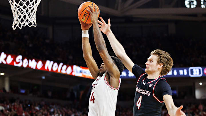 Stephen Clark contests a dunk attempt from Davonte Davis in South Carolina basketball's recent win over Arkansas. 