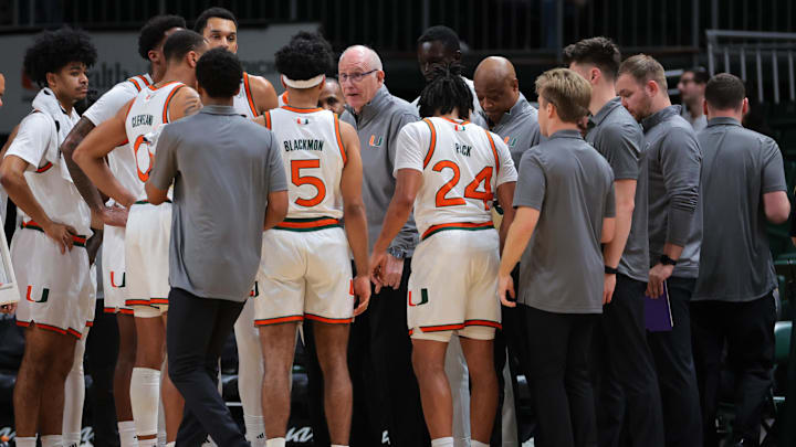 Dec 7, 2024; Coral Gables, Florida, USA; Miami Hurricanes head coach Jim Larranaga talks to his players during a timeline against the Clemson Tigers in the first half at Watsco Center. Mandatory Credit: Sam Navarro-Imagn Images