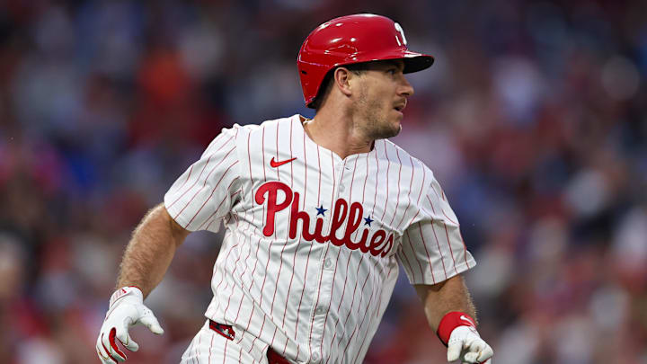 Sep 10, 2025; Philadelphia, Pennsylvania, USA; Philadelphia Phillies catcher J.T. Realmuto (10) hits an RBI single against the New York Mets during the first inning at Citizens Bank Park. Mandatory Credit: Bill Streicher-Imagn Images