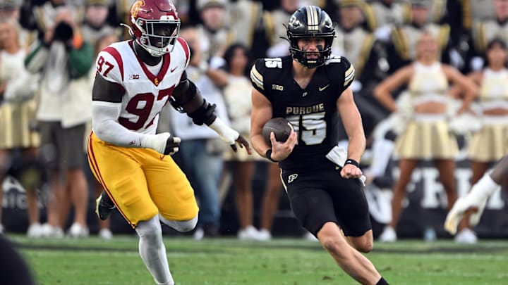 Purdue Boilermakers quarterback Ryan Browne (15) is chased by USC Trojans defensive tackle Jide Abasiri (97) 