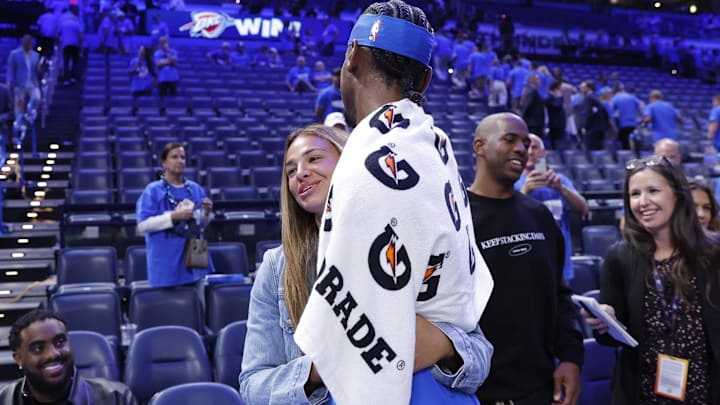 Oklahoma City Thunder guard Shai Gilgeous-Alexander (2) hugs his wife, Hailey Summers, after defeating the Minnesota Timberwolves during Game 2 of the Western Conference Finals for the 2025 NBA Playoffs.